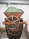 Crusher on top of "Must" Barrel with Grapes